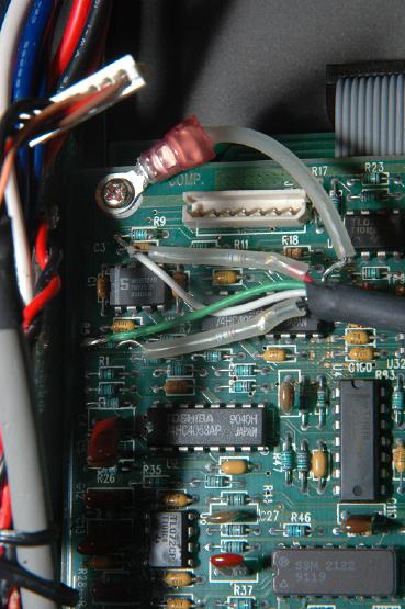 K2000 Synth End.JPG - Here are the power leads for the sampler module. There is a green wire connected to R5. A white wire connected to R9. Then there are red and black wires with a resistor inline stuffed inside a clear tube. The last connection is the ground wire, with a clear tube isolating it from the rest of the board, secured to a phillips head screw.